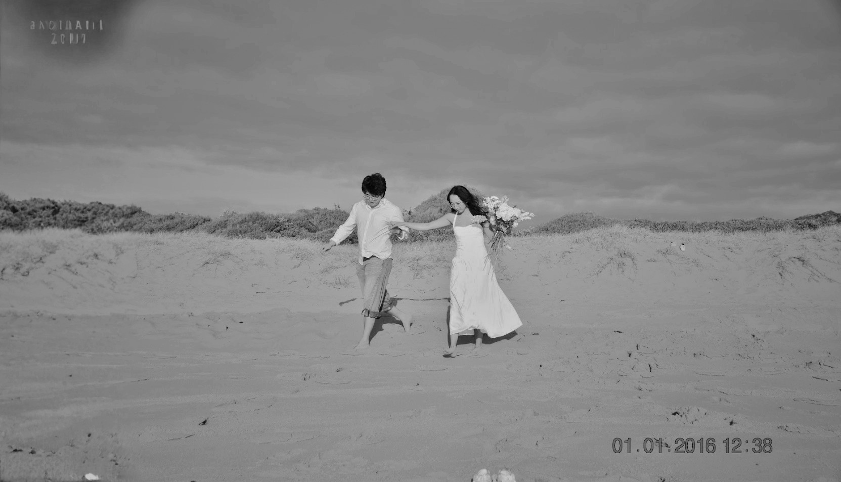 Belinda and Thomas walking together on the beach